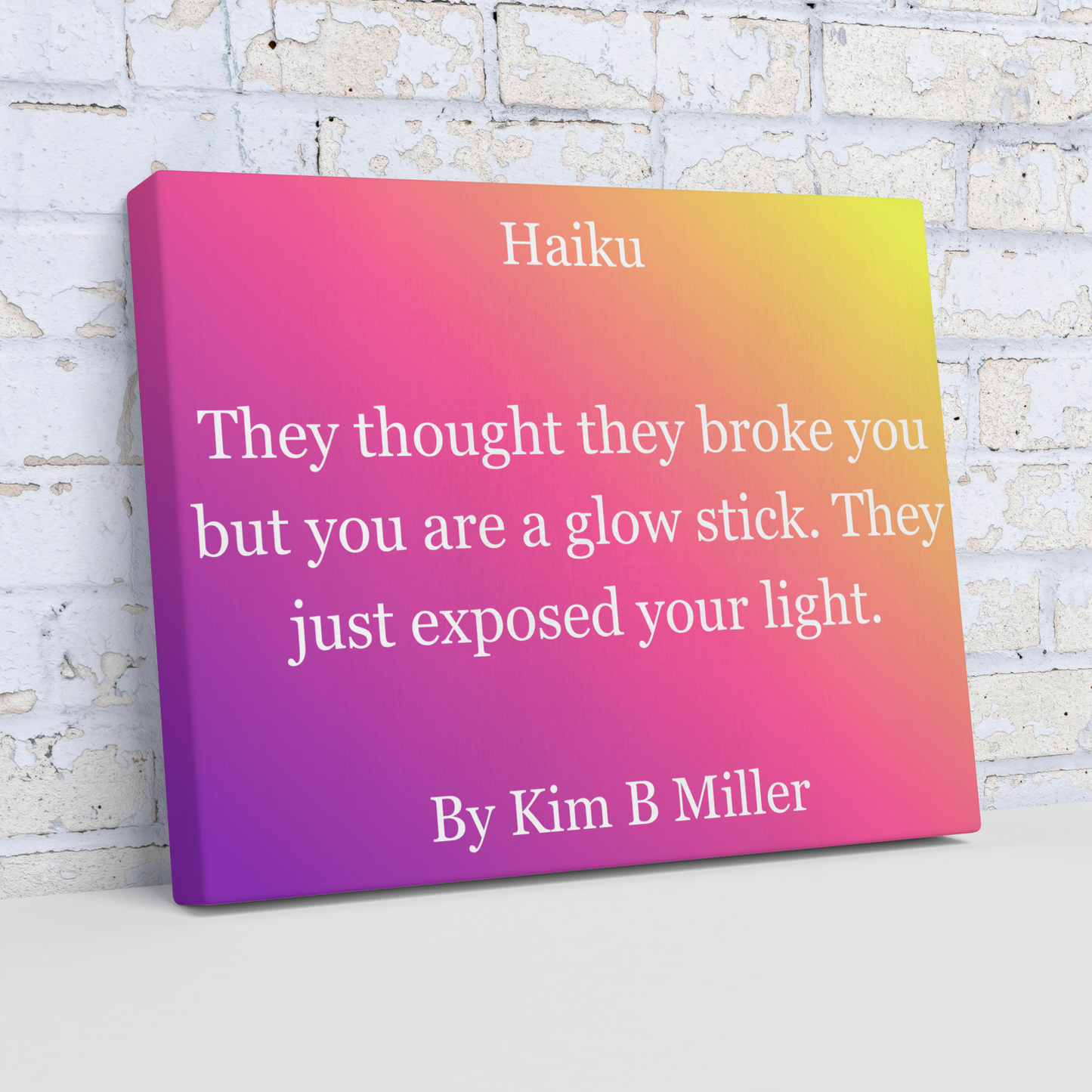 Kim B Miller canvas wall art featuring an original haiku on a minimalist fading-pink background, shown at an angle.