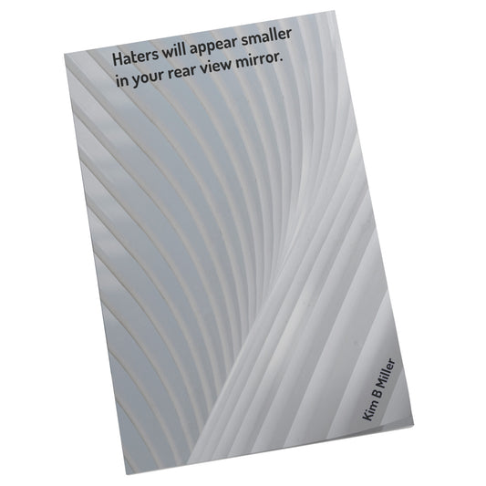 One, 4" x 6" sticky note featuring Kim B Miller’s affirmation, “Haters will appear smaller in your rear view mirror,” printed in full color on the front, angled view.