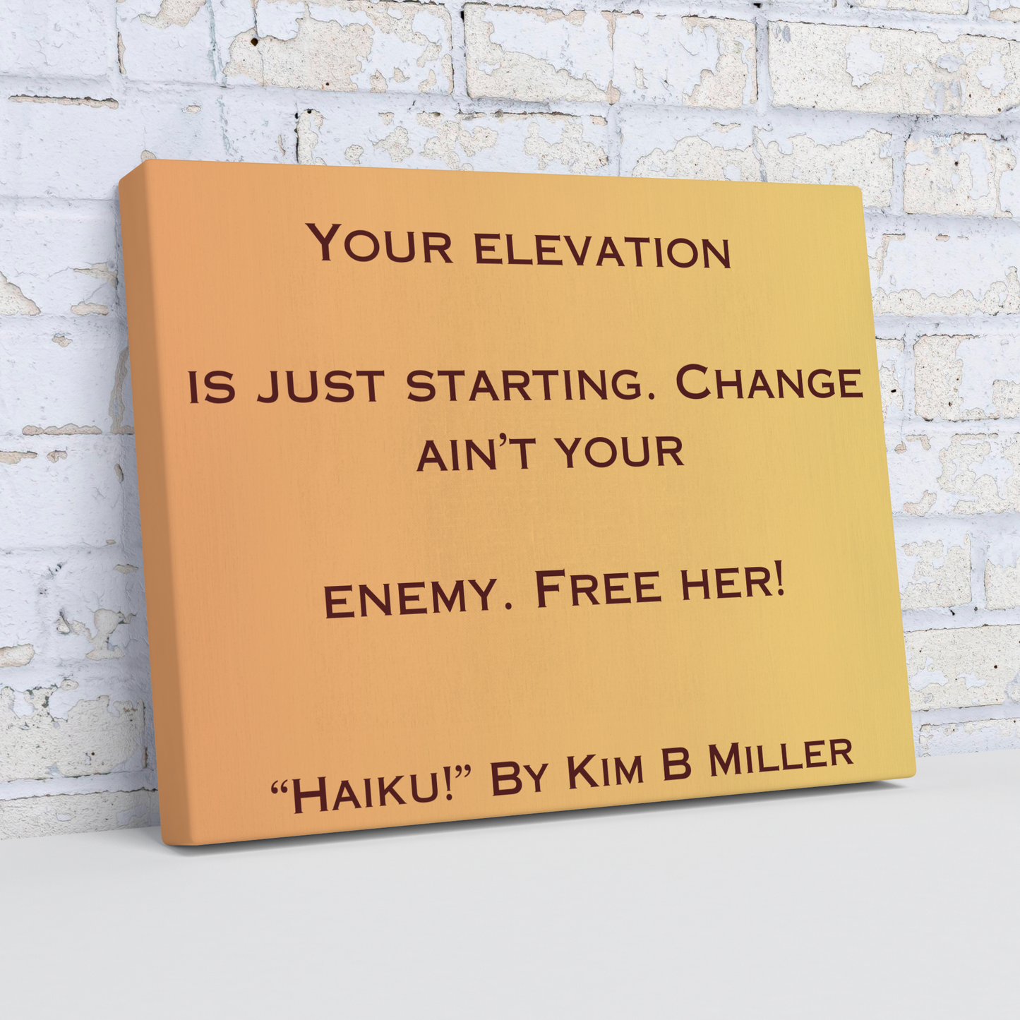 A canvas with a warm yellow-to-orange gradient, featuring an original haiku by Kim B Miller, angled view.