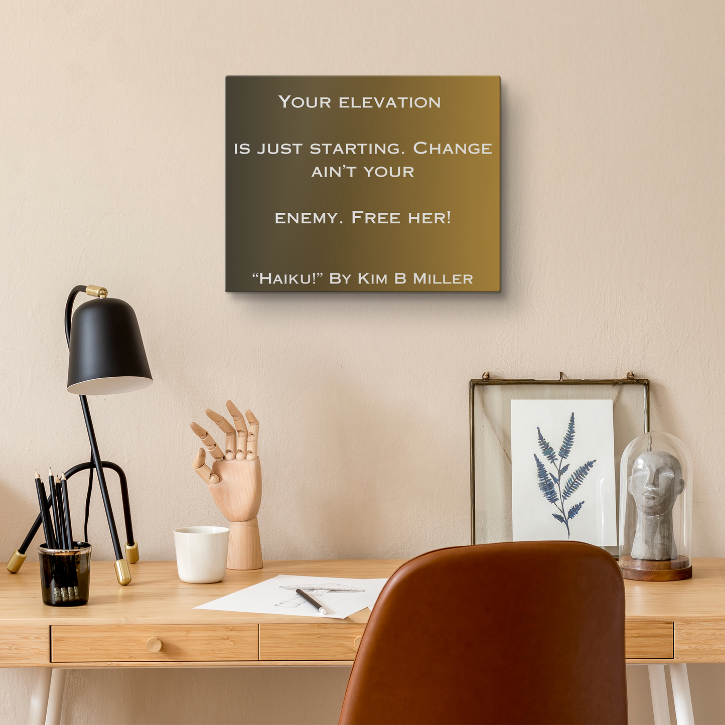 Kim B Miller canvas wall art featuring an original haiku on a minimalist brownish background, above a desk.