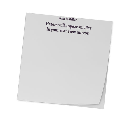 One, 3x3 sticky note pad featuring Haters will appear smaller in your rear view mirror written by Kim B Miller, angled view.